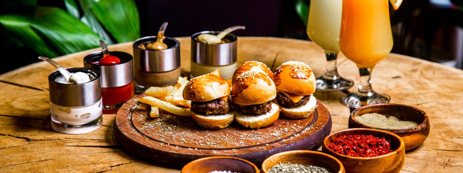 mini-burgers-french-fries-spices-sauces-cocktails-side-view
