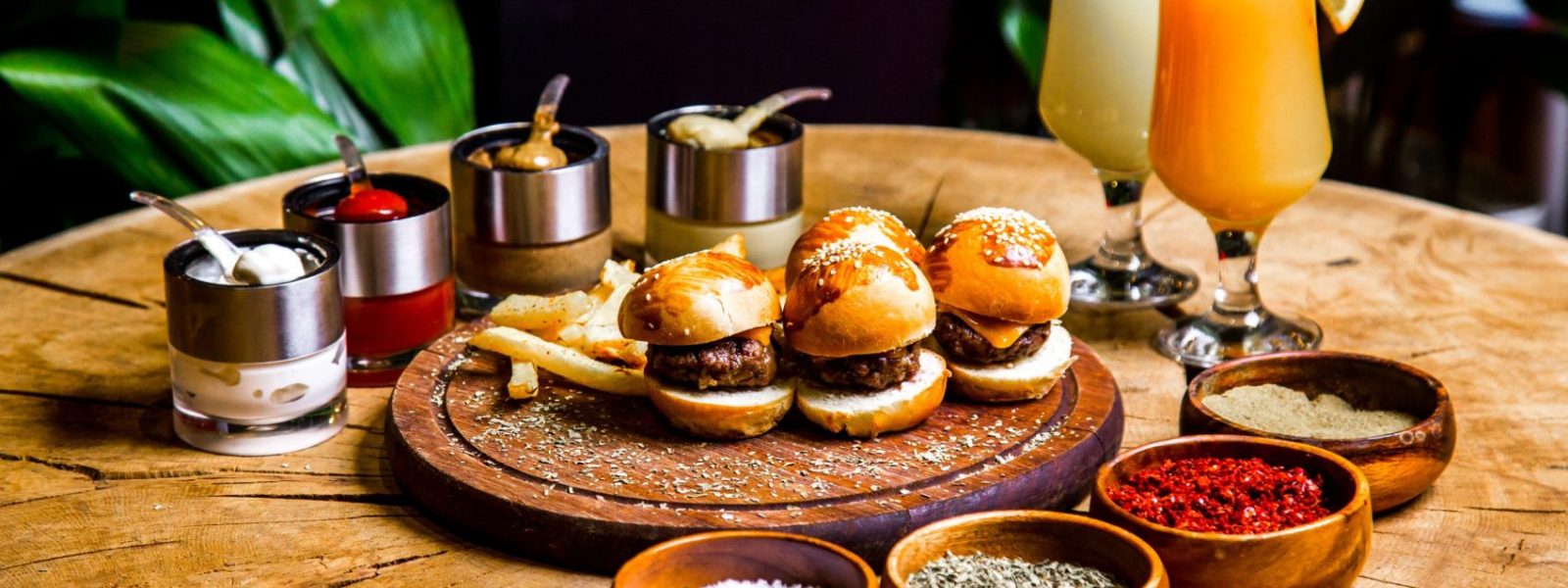 mini-burgers-french-fries-spices-sauces-cocktails-side-view